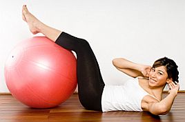 Woman exercising with abdominal fitness equipment